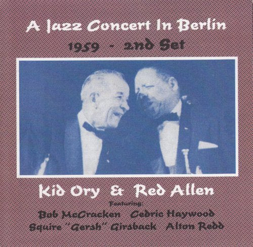 "CD cover with red background, featuring blue-toned image of two men in tuxedos."