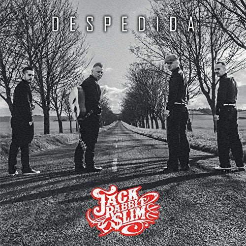 "Black and white album cover with four men standing on a road."