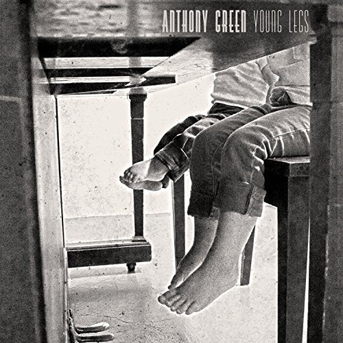 Black and white album cover featuring a person sitting on a wooden bench.
