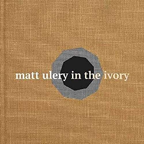 "CD cover with tan burlap background, gray and black octagon, and white text."