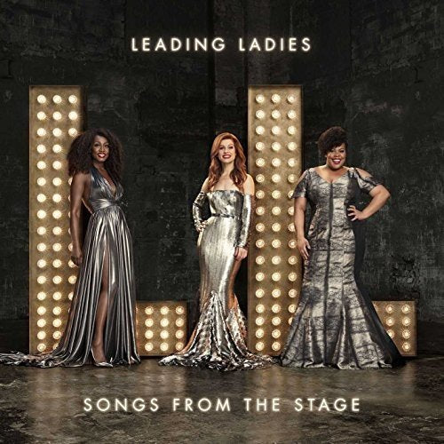 "CD cover featuring three women in silver dresses standing by lit-up panels."