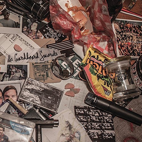 "Cluttered image of various items, including photos, papers, and miscellaneous objects."
