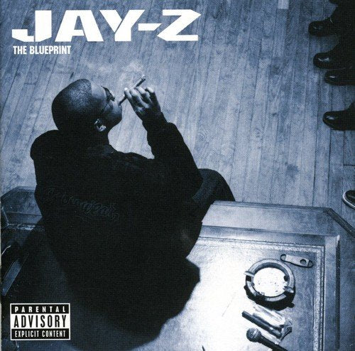 Jay-Z sits smoking a cigar on the cover of his album The Blueprint.