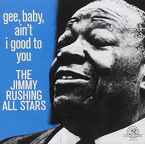 Album cover with black and white portrait of man singing, blue background, white text.