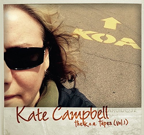 Album cover featuring a woman's face and "KOA" painted on asphalt.