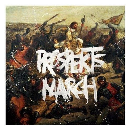 "Black album cover with gold 'Viva la Vida' text and white paint splatters."