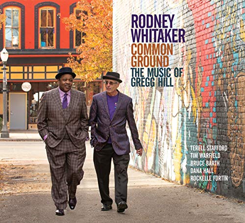 "Album cover featuring two men walking down a street with a colorful wall."