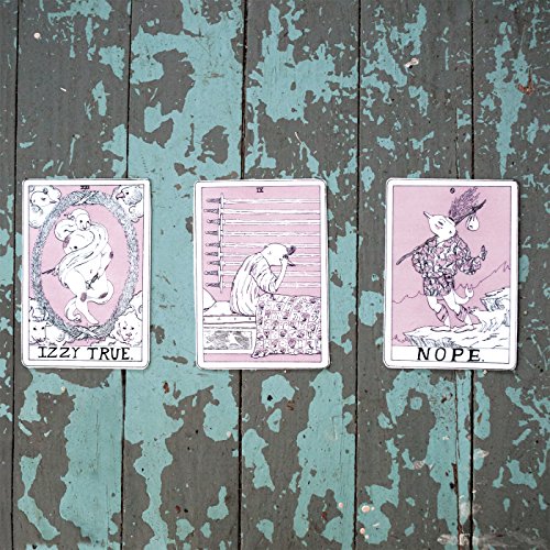 Three tarot-style cards with animal figures on a weathered blue surface.