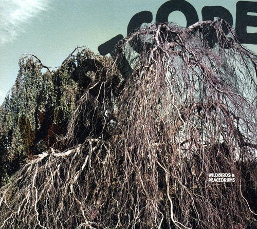 Album cover with a rocky, root-covered hill and the word "heartcore" in large letters.