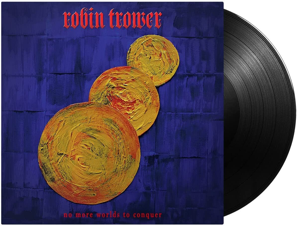 Vinyl record with blue album cover featuring three yellow spheres and red text.