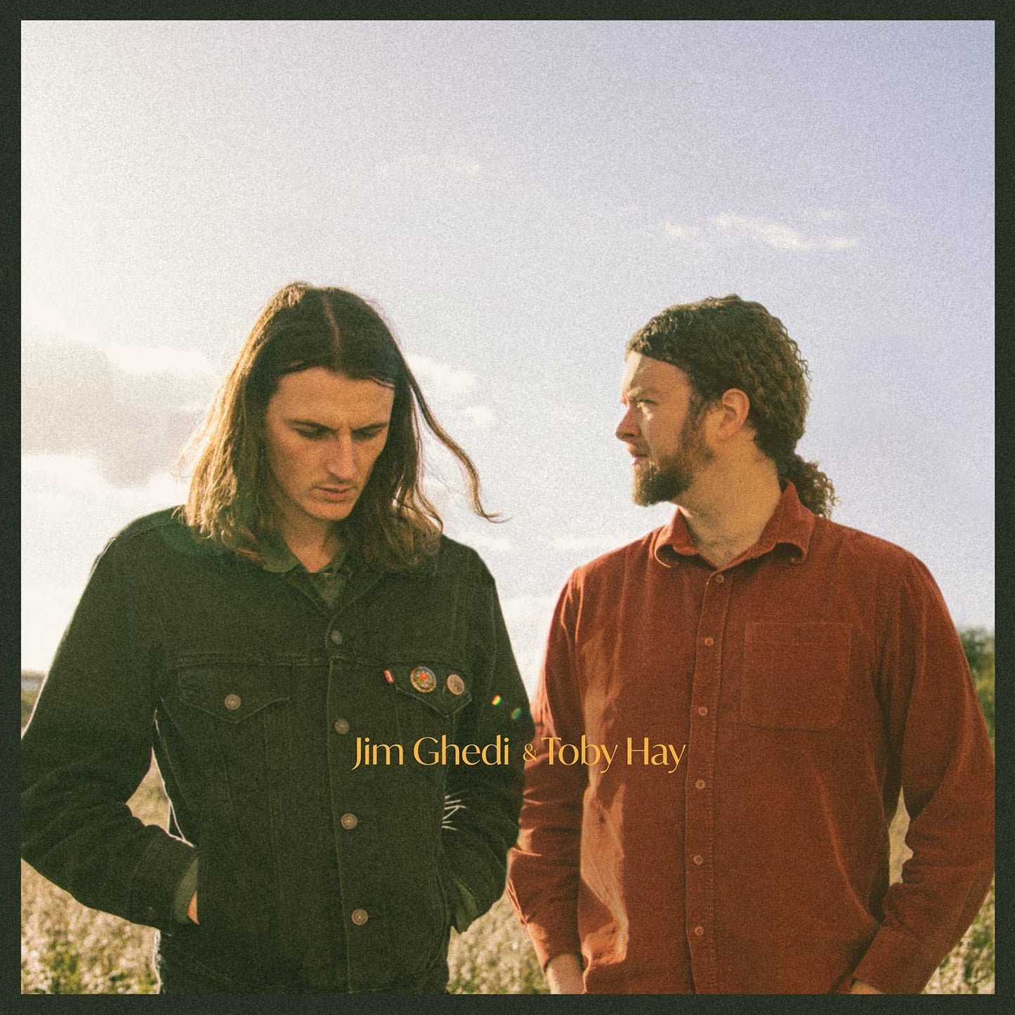 "Album cover featuring two men standing outdoors, with names 'Jim Ghedi & Toby Hay'."
