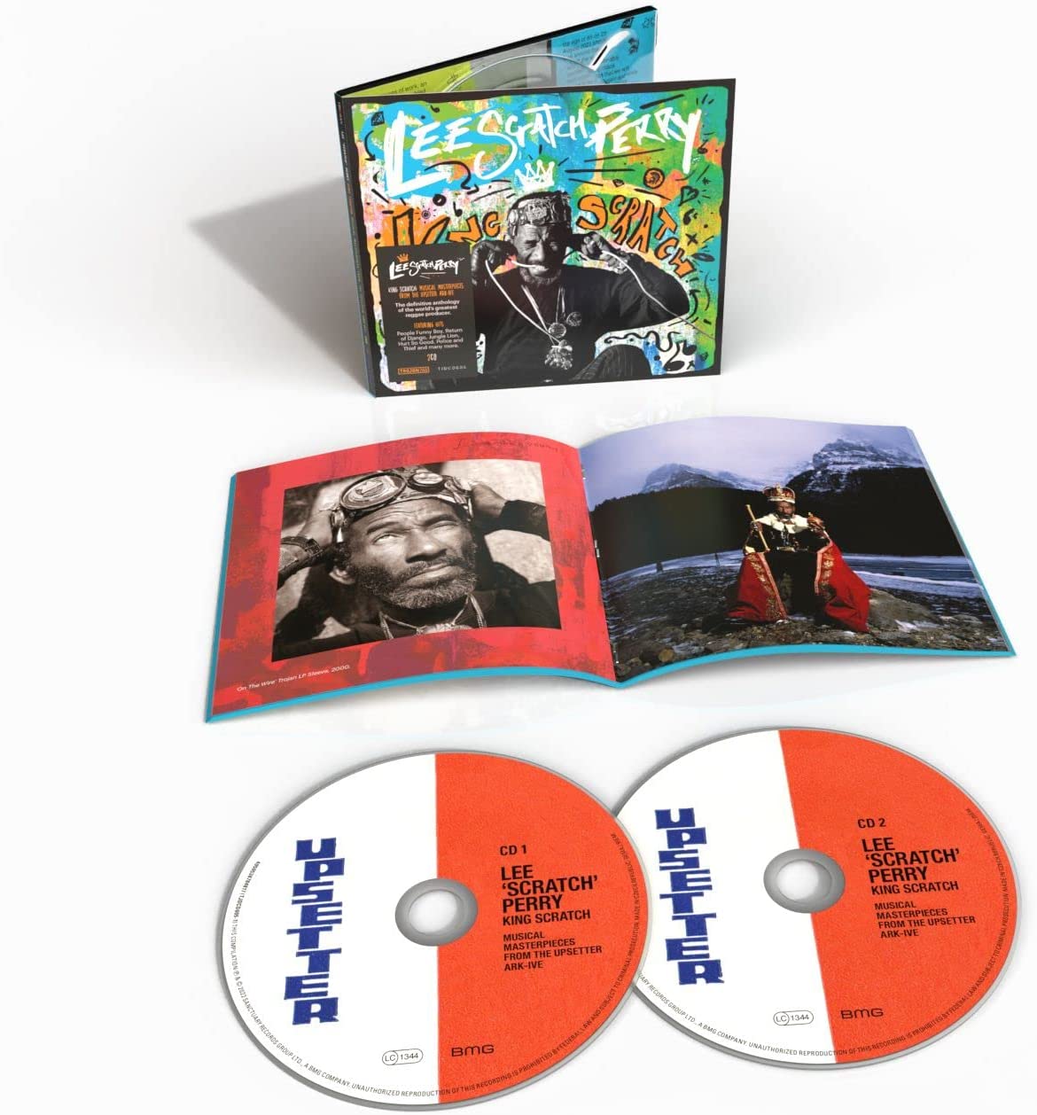 "CD case and two discs with orange and white labels, open booklet with photos."