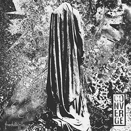 A black and white album cover with a hooded figure and distressed background.