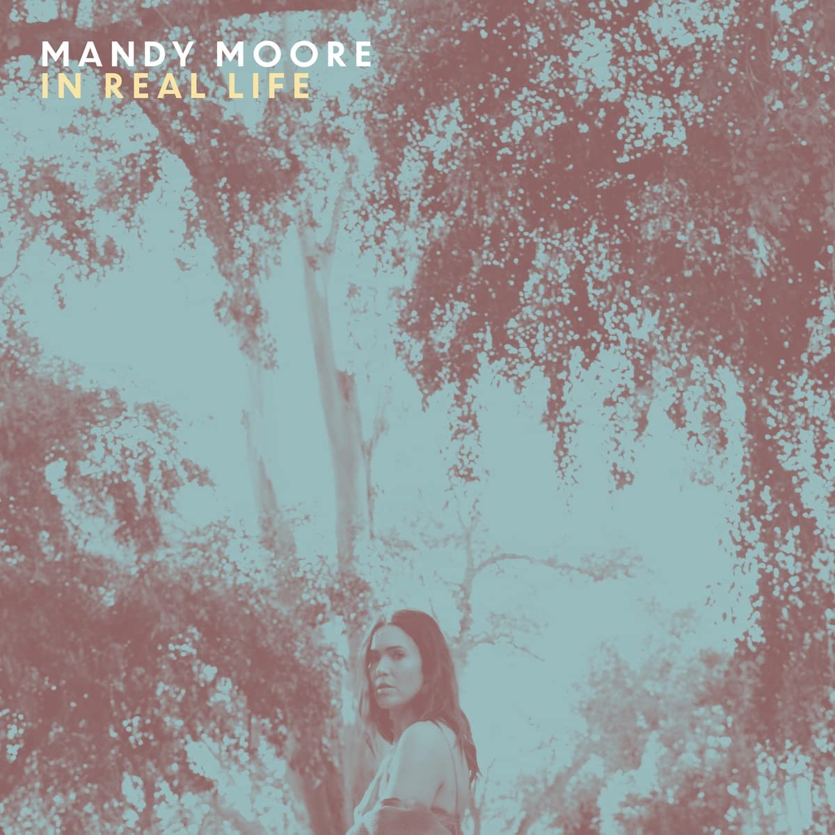 CD cover for Mandy Moore’s “In Real Life” featuring a woman in trees.
