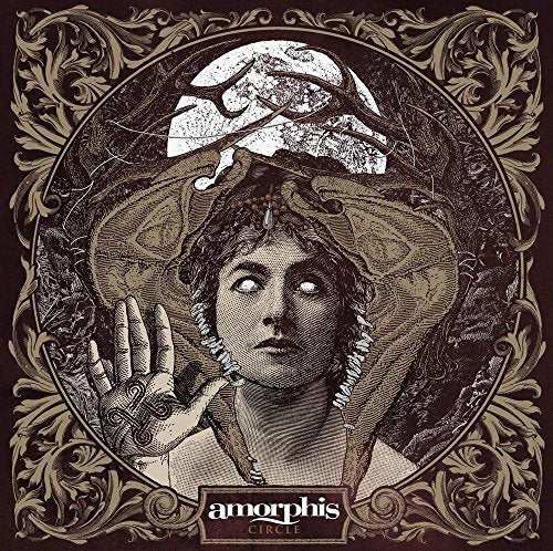 "Album cover art featuring a woman with glowing eyes surrounded by ornate, brown design."