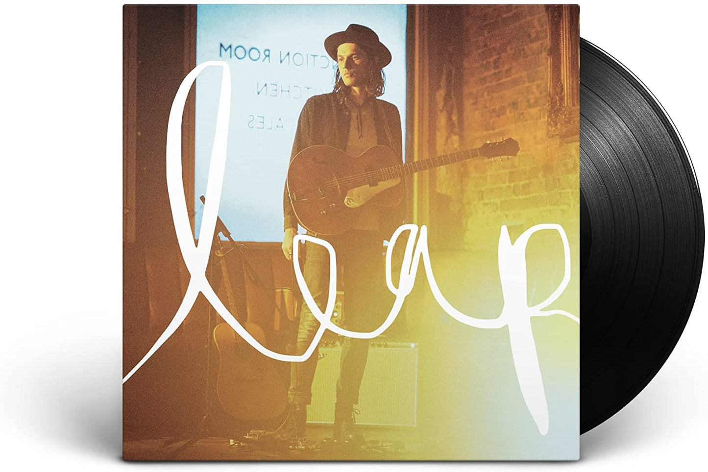 Man holding guitar stands on stage with "leap" written across the image.