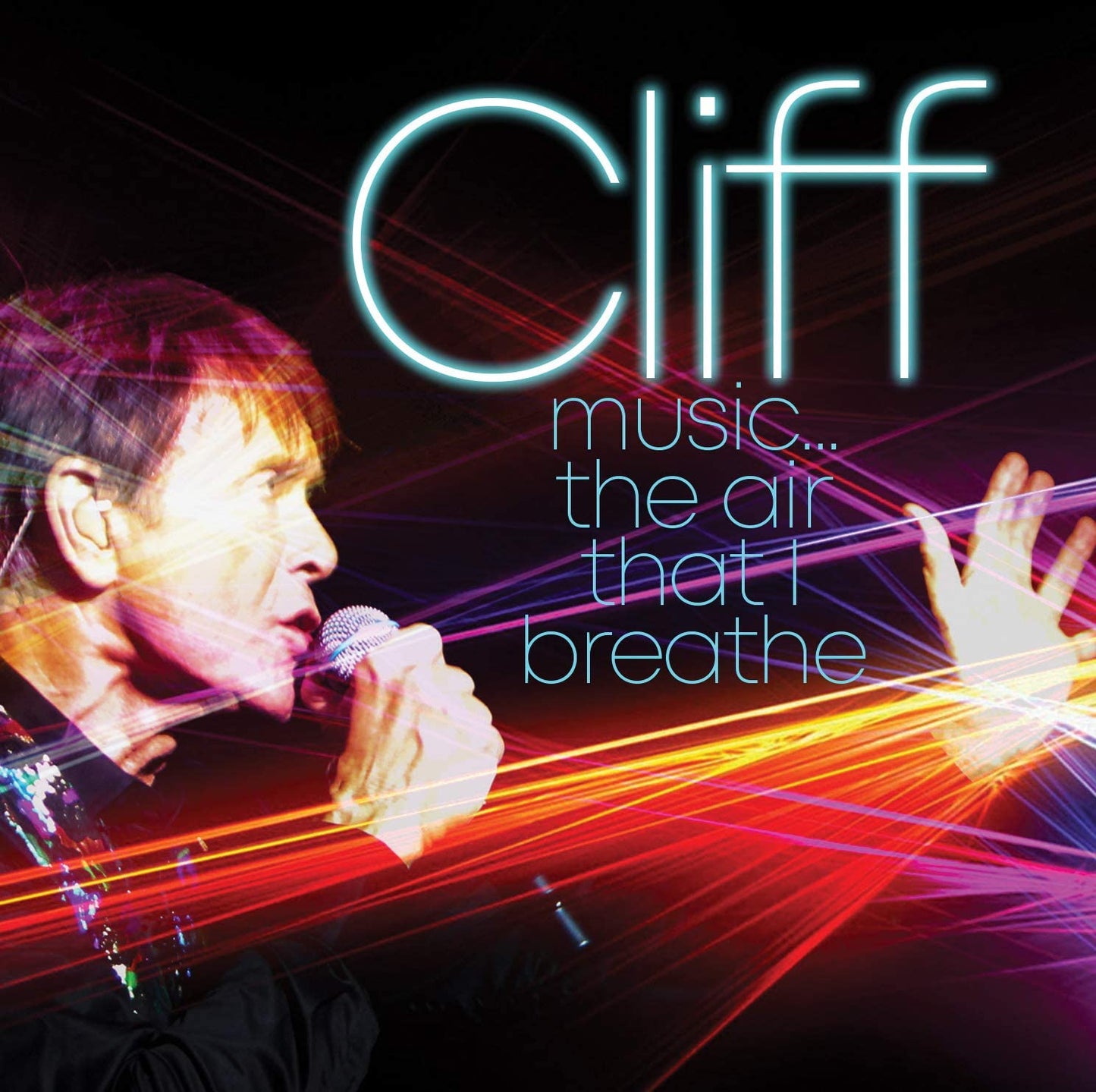 Cliff Richard singing into a microphone, surrounded by red and orange light streaks.