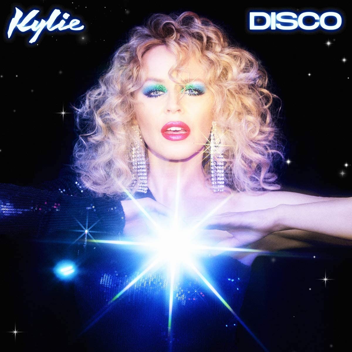 Kylie Minogue album cover featuring a blonde woman with bright makeup and a disco ball.