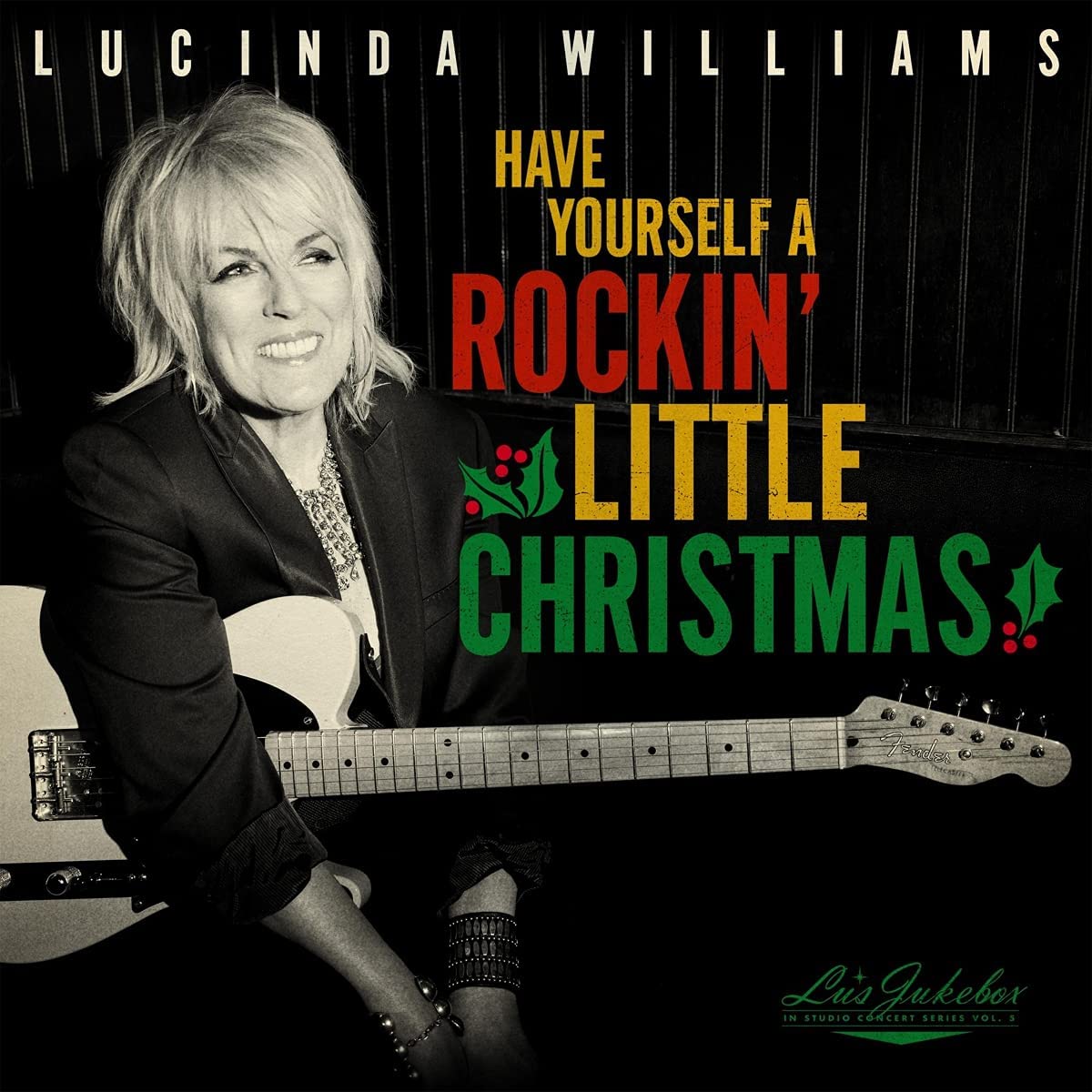 Lucinda Williams album cover featuring her with a guitar, Christmas theme.