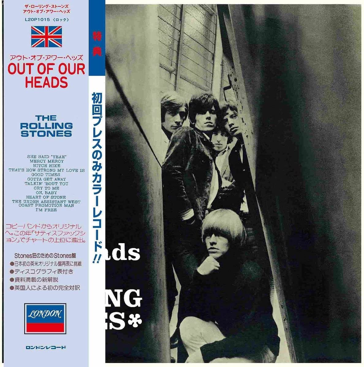 "Black and white album cover featuring The Rolling Stones in a narrow alleyway."