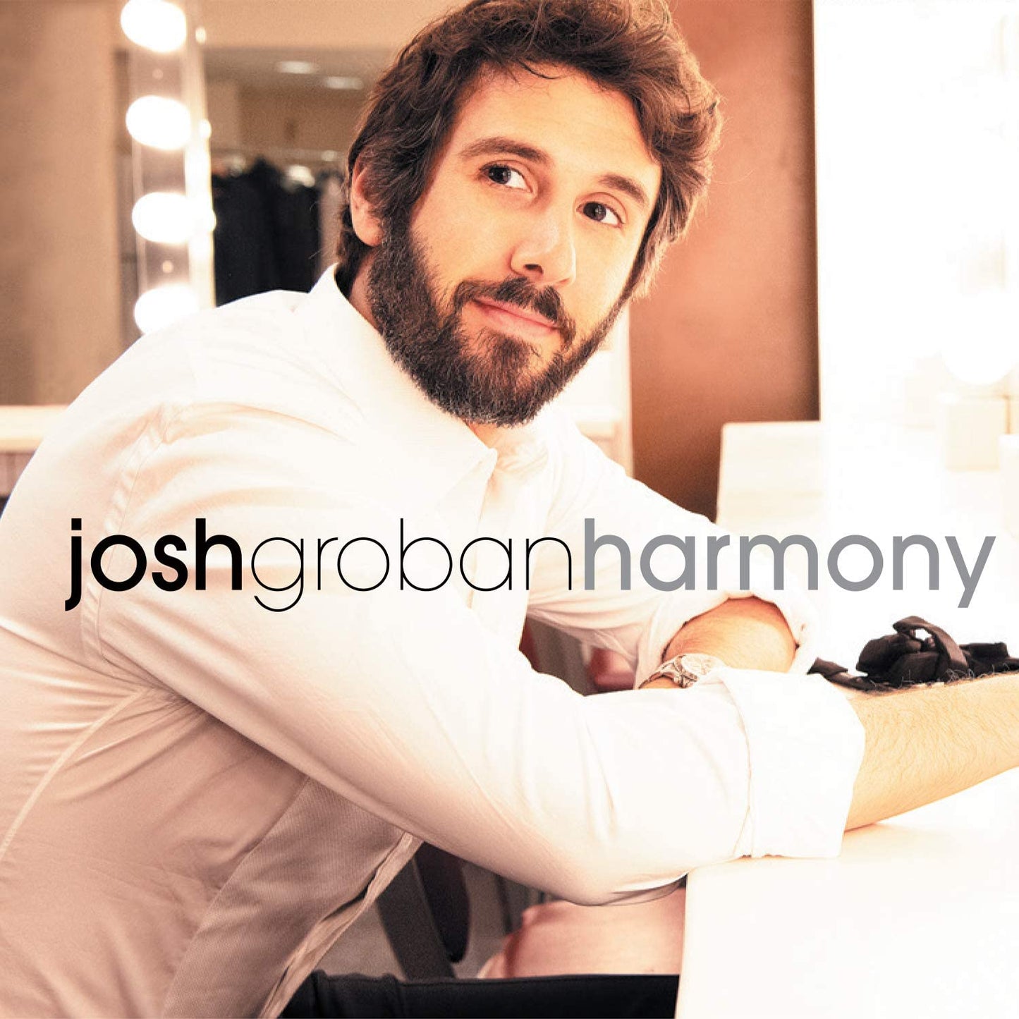 "Josh Groban album cover featuring a man with a beard in a white shirt."