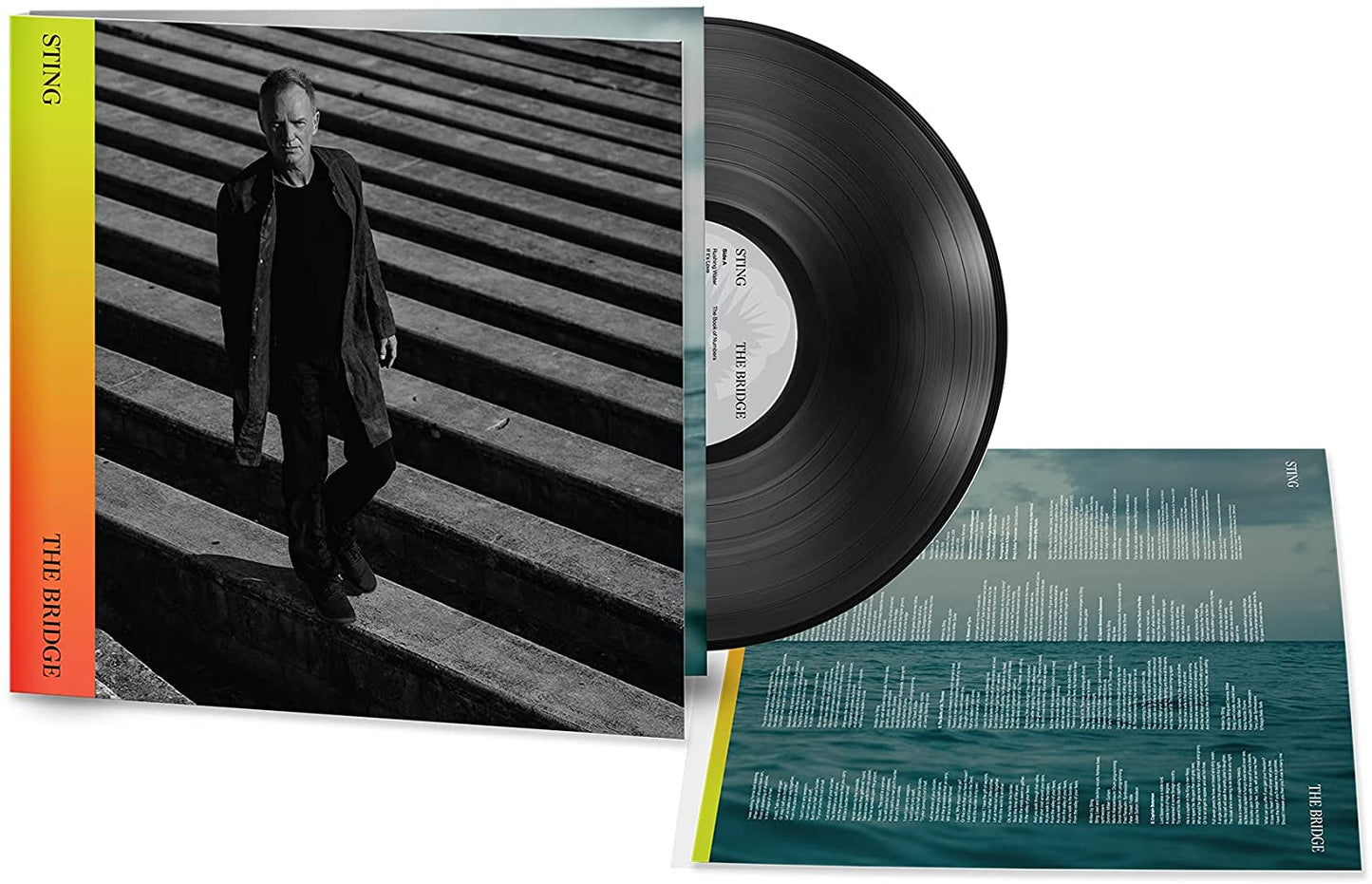 Vinyl record with cover featuring man on stairs and inner sleeve with cityscape design.