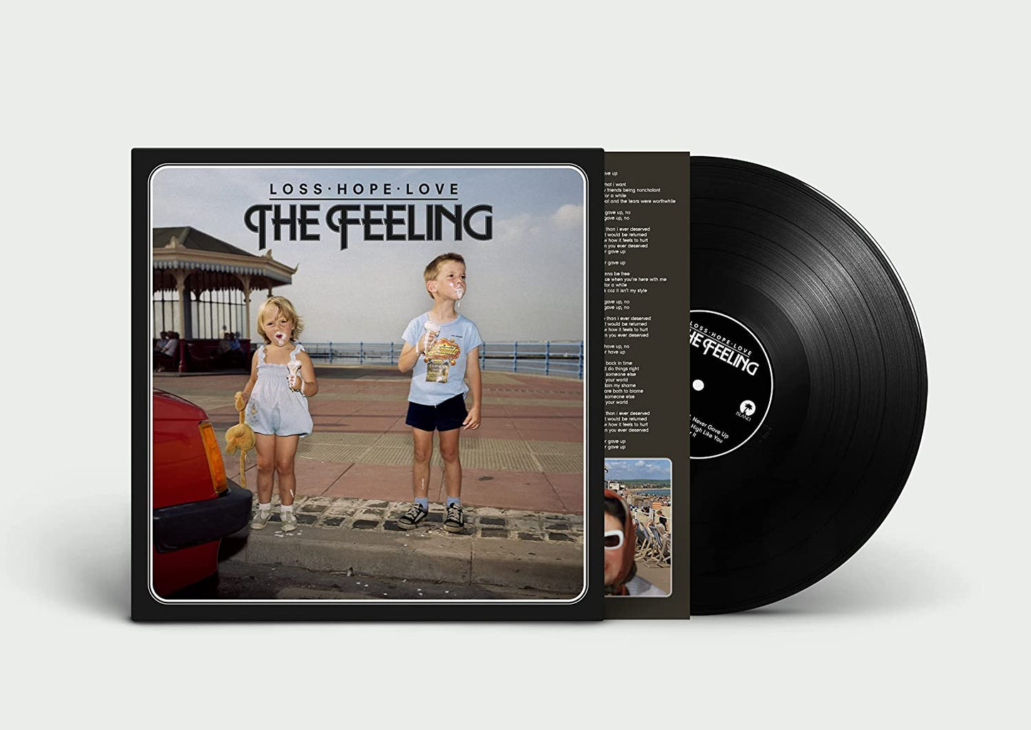 Vinyl record cover featuring two children blowing bubbles on a seaside promenade.