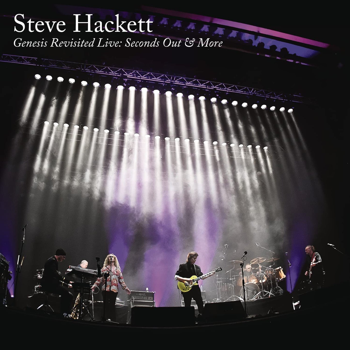 "Album cover featuring a band performing on stage under bright stage lights."