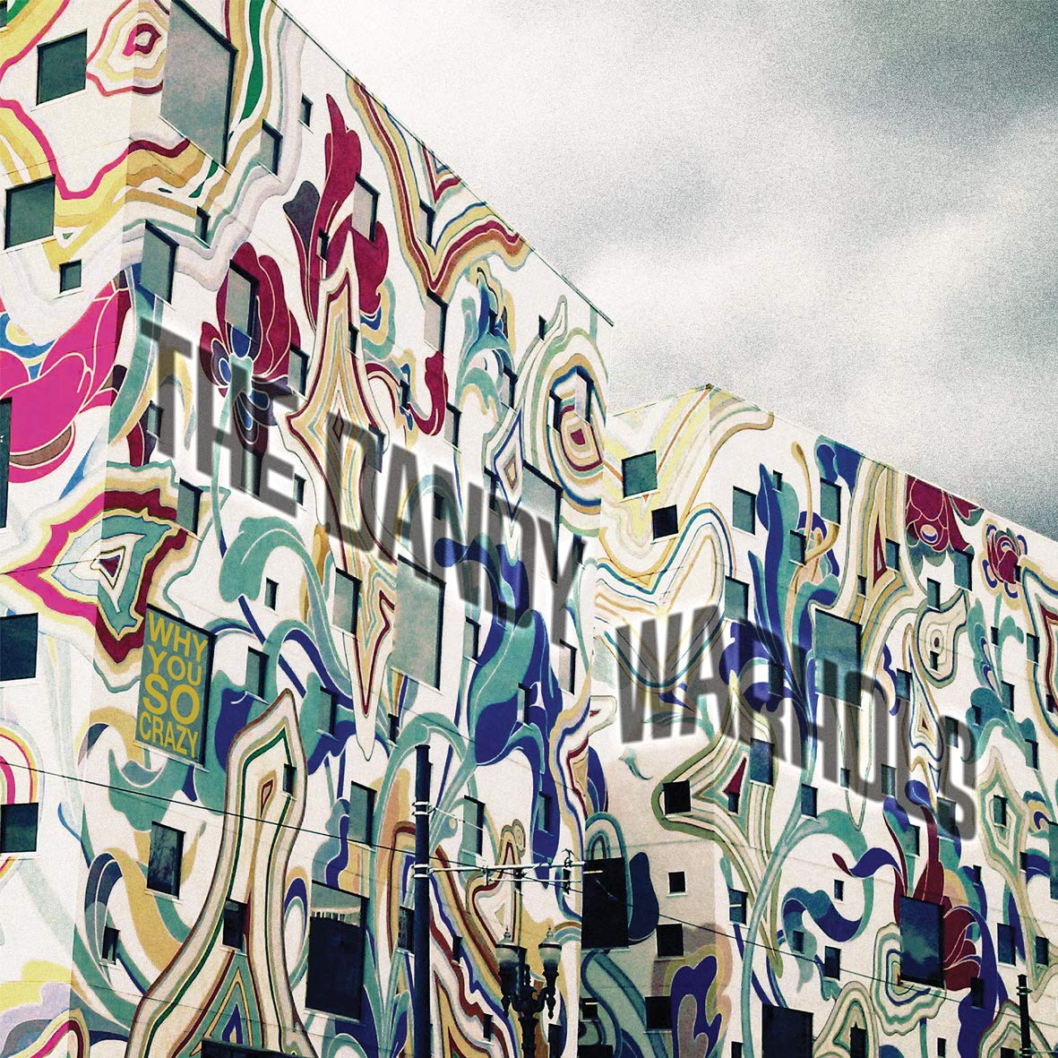 "Album cover for 'The Dandy Warhols' with abstract, colorful mural on a building."