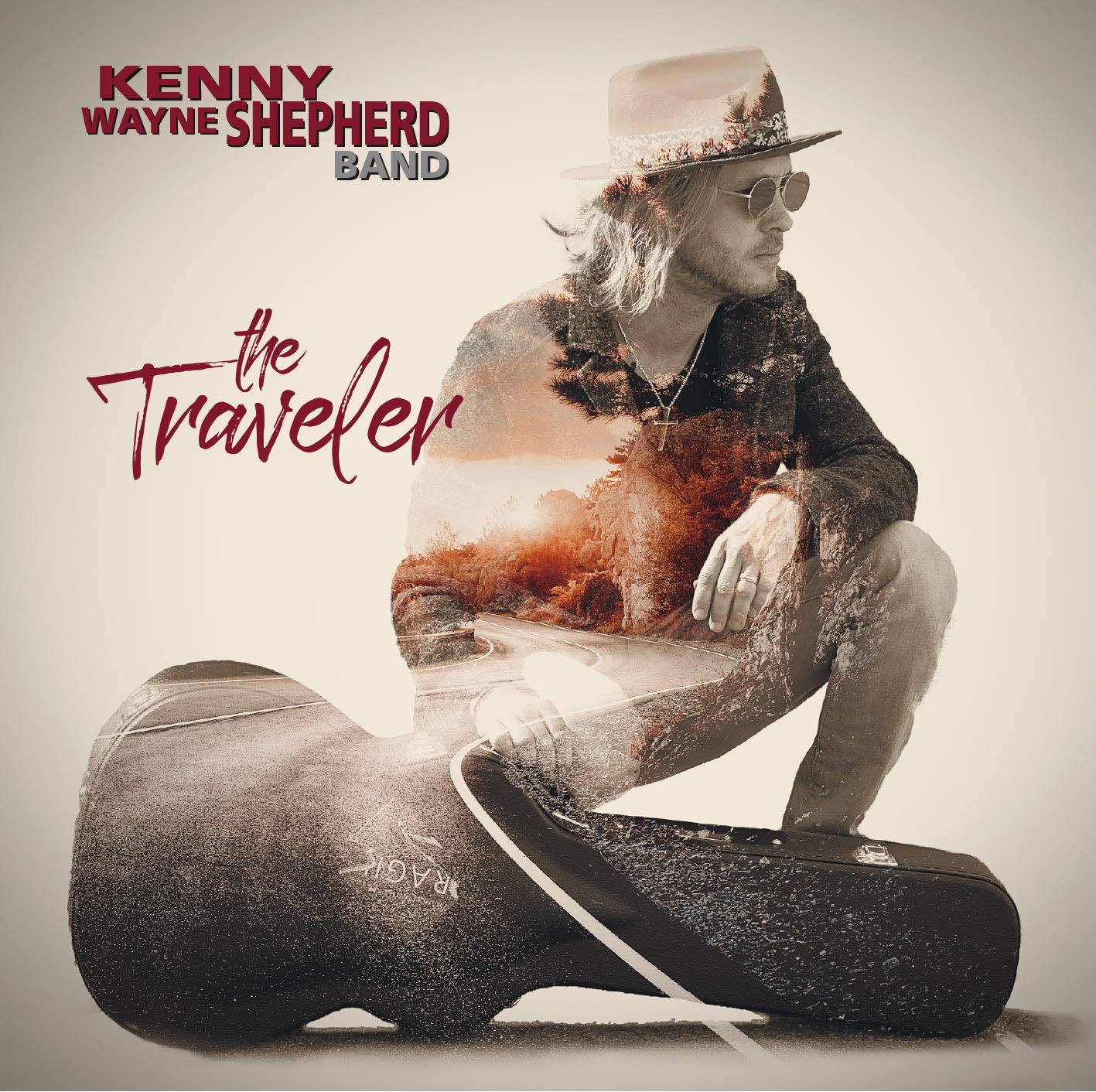 Kenny Wayne Shepherd Band album cover featuring a man crouching beside a guitar case.
