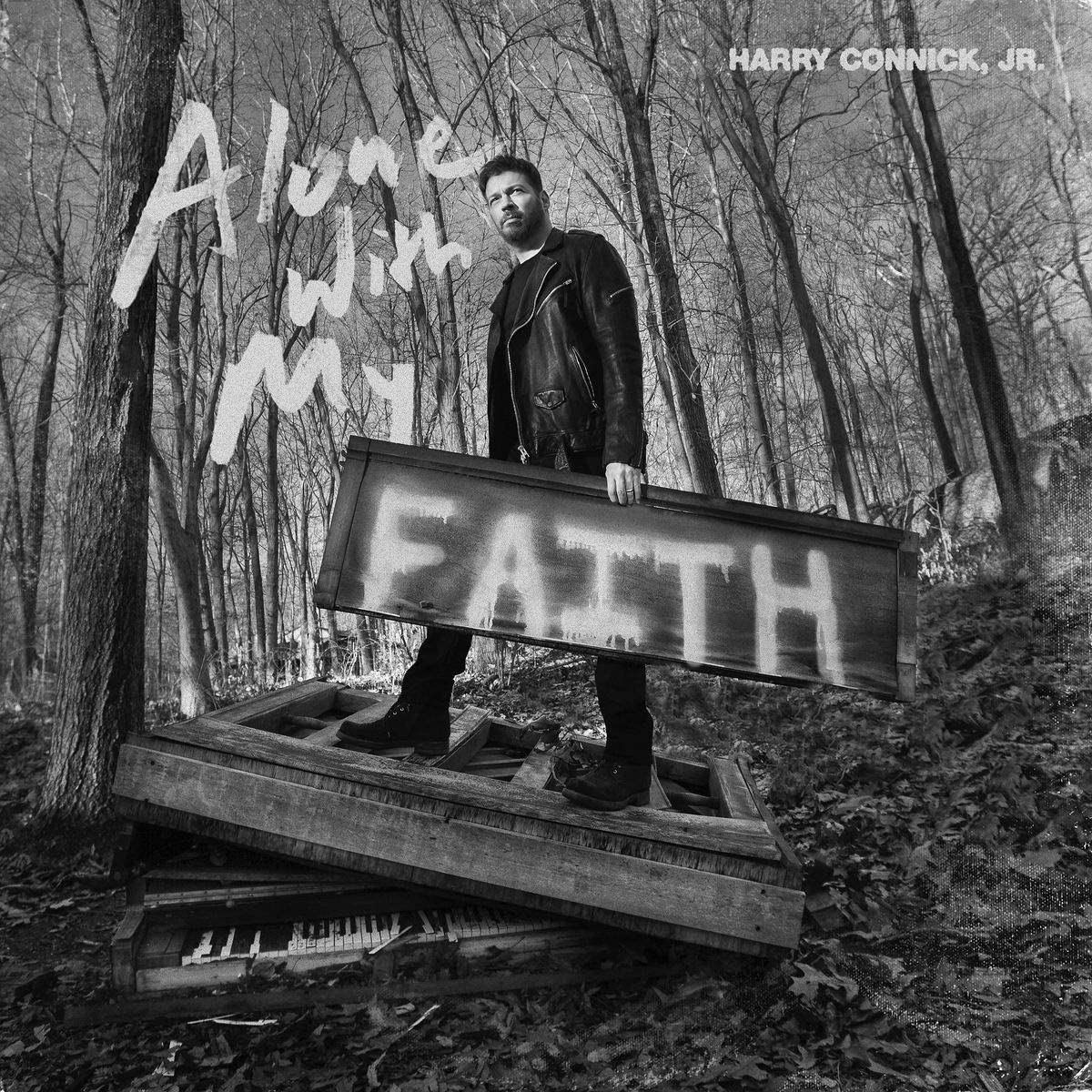 "Black and white album cover with Harry Connick Jr. holding a 'FAITH' sign."