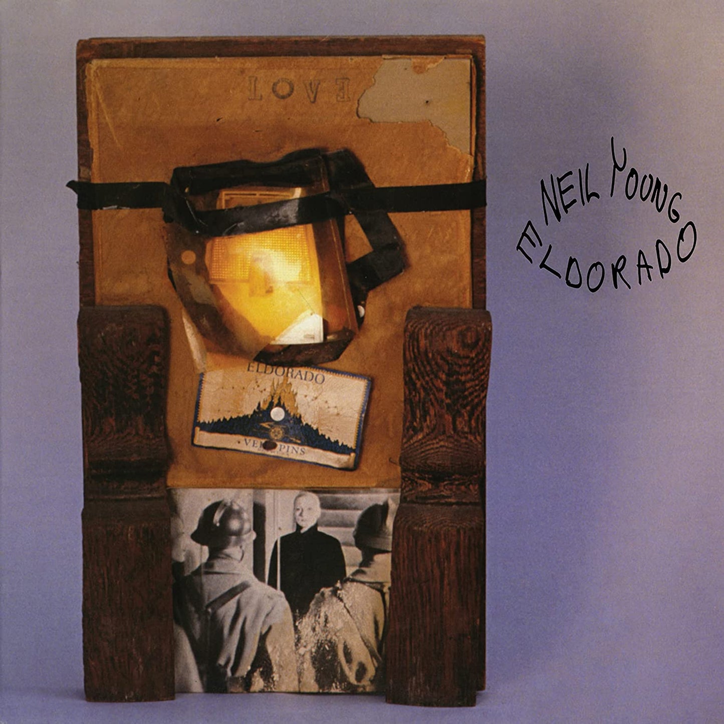A brown, wooden box with a black ribbon and a photograph on the front.