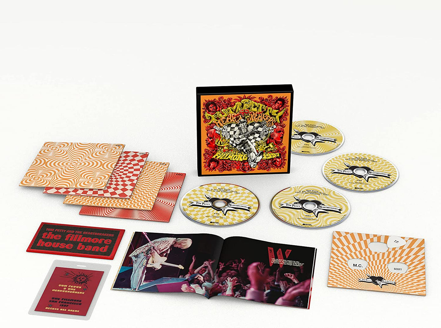 "CD box set with discs, booklets, and cards on a white background."