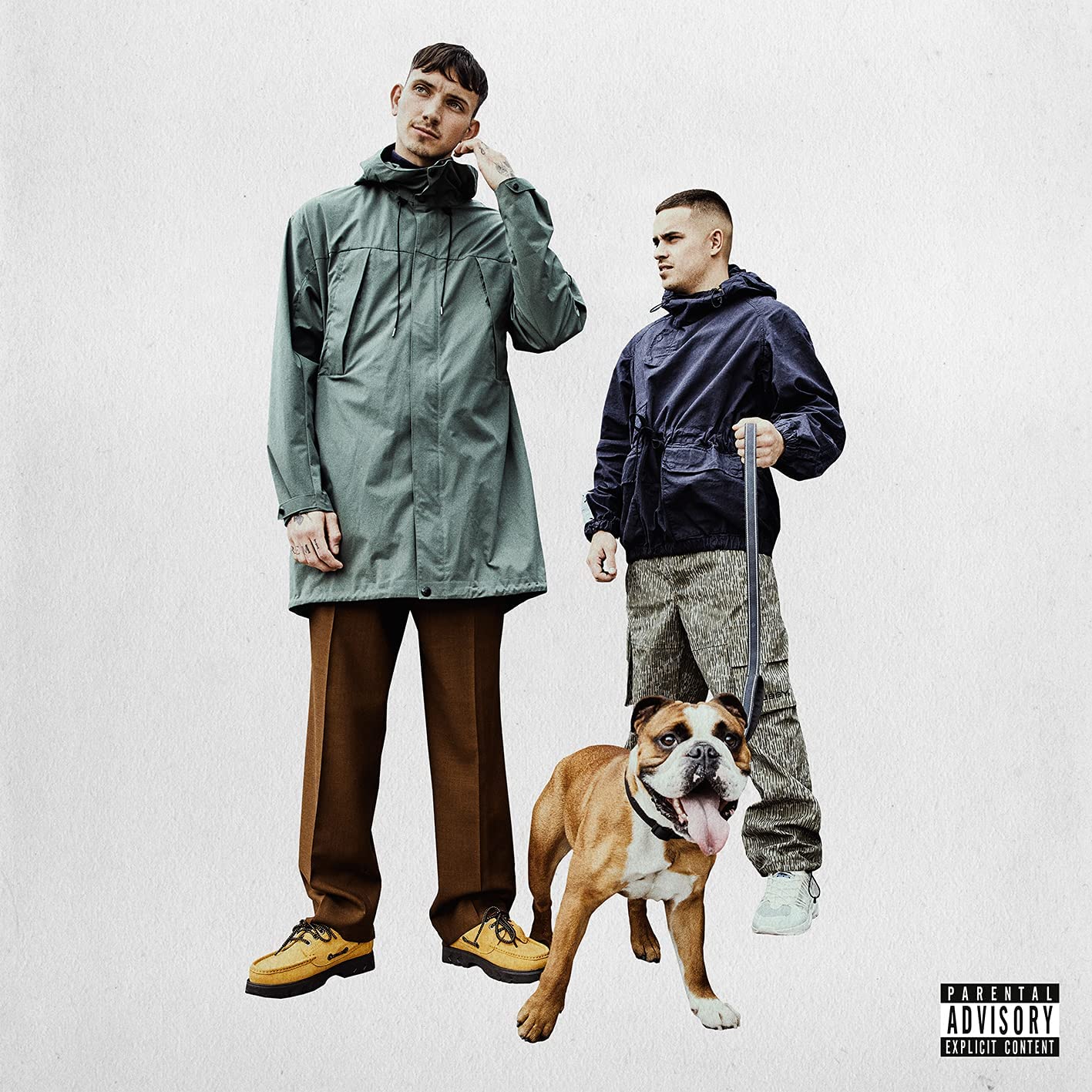 Two men and a dog stand against a white, textured background.