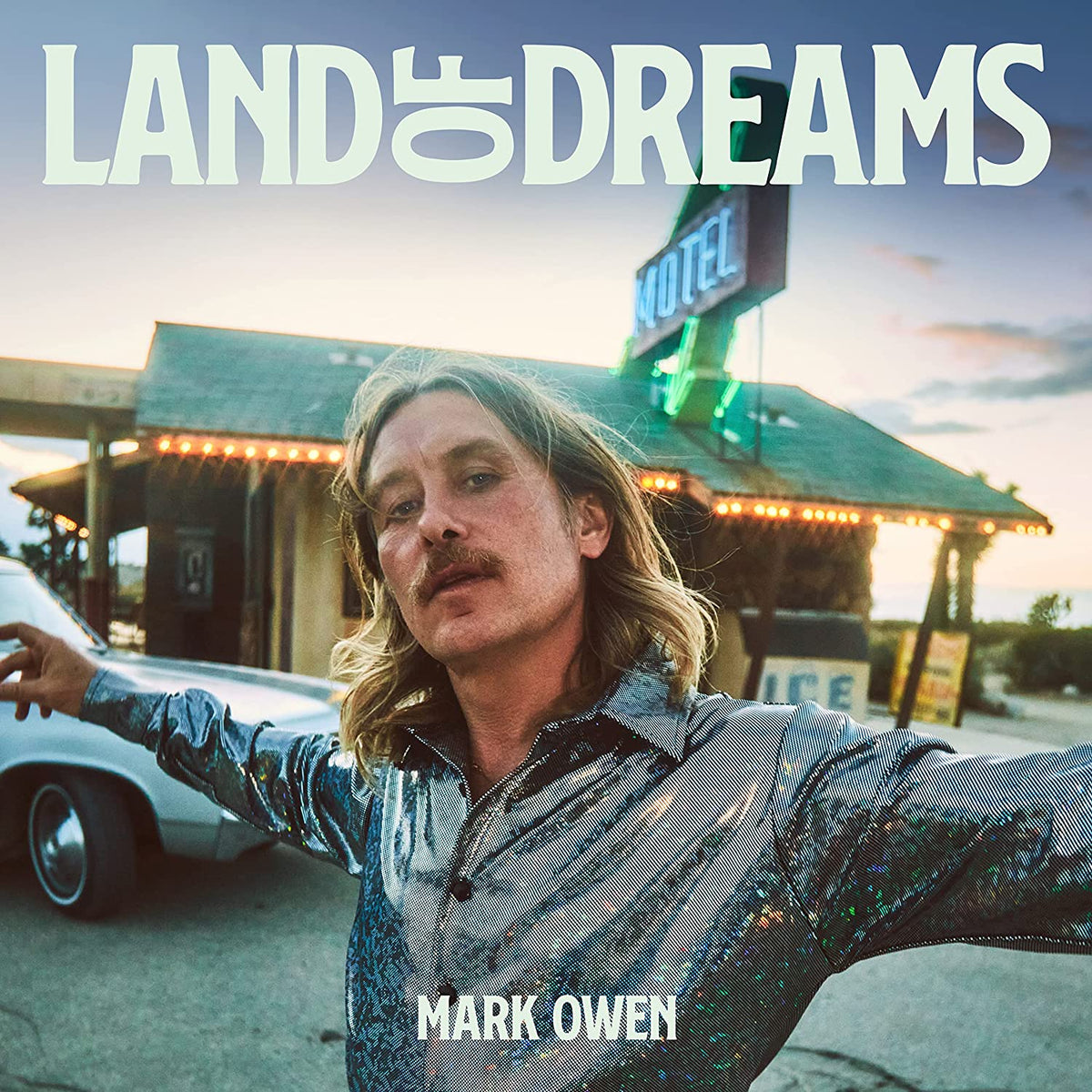 Mark Owen album cover featuring a man in front of a motel.