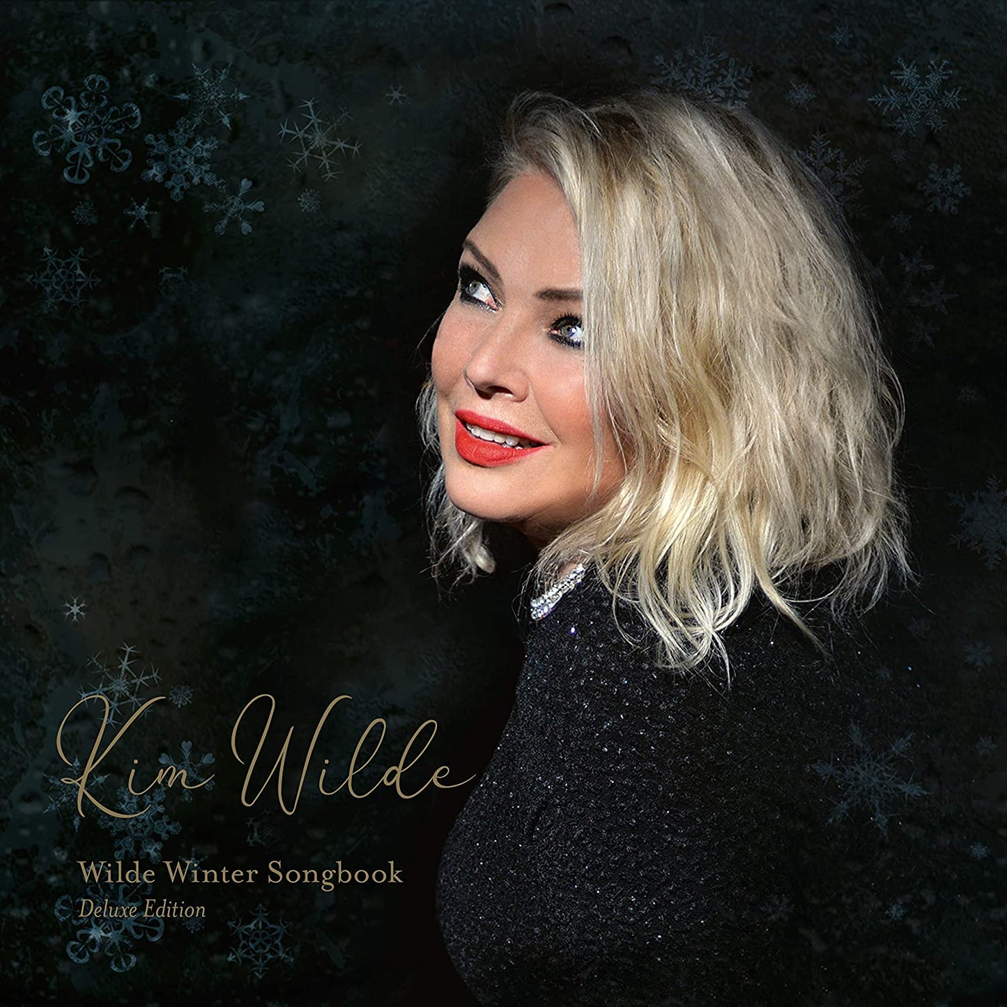 Kim Wilde album cover featuring a blonde woman against a dark, snowflake-patterned background.