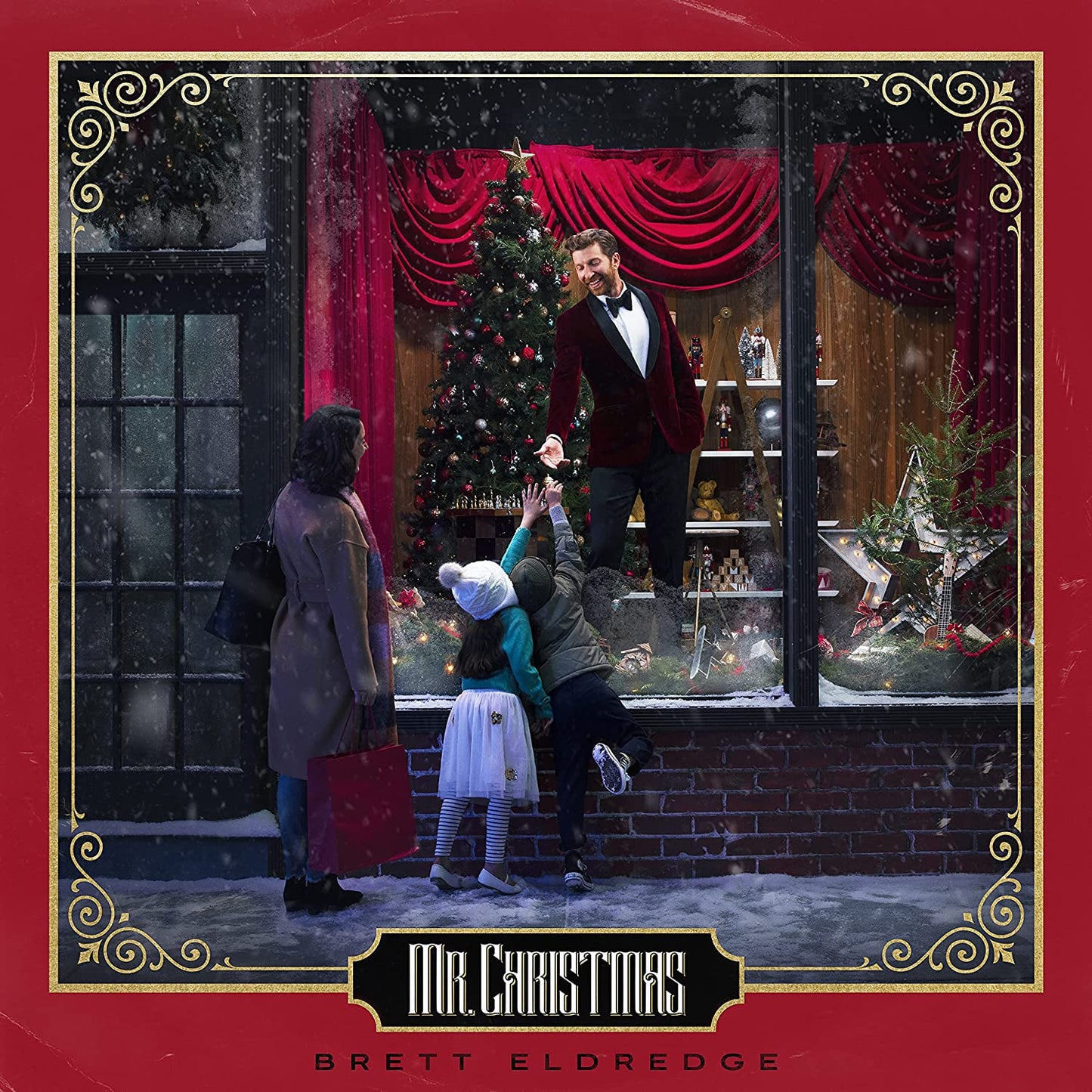 "Red album cover with man in tuxedo in a shop window and children outside."