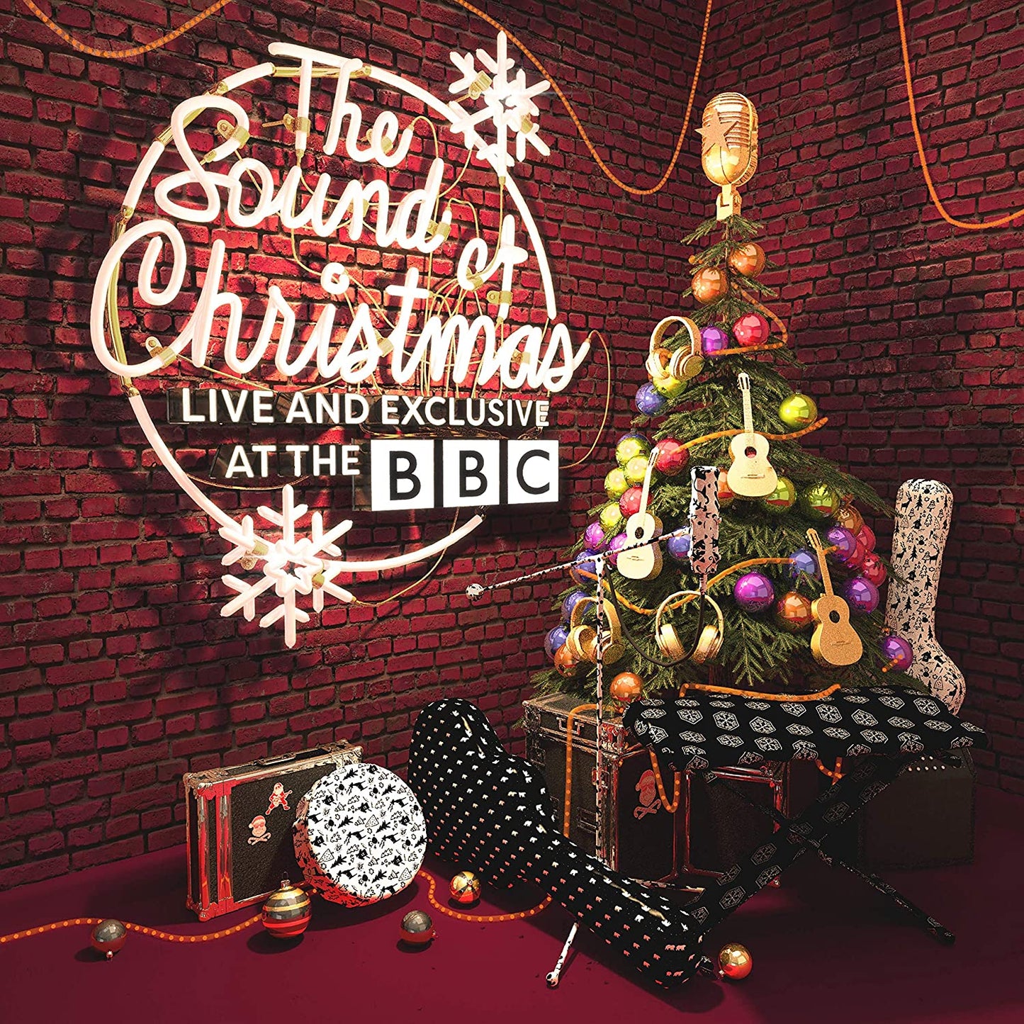 "Christmas album cover featuring a decorated tree and musical instruments against a brick wall."