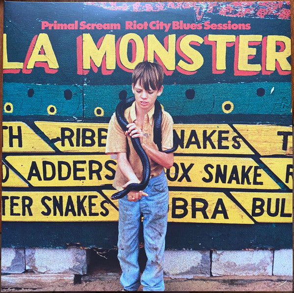 Vinyl record cover: boy with a snake in front of a sign.