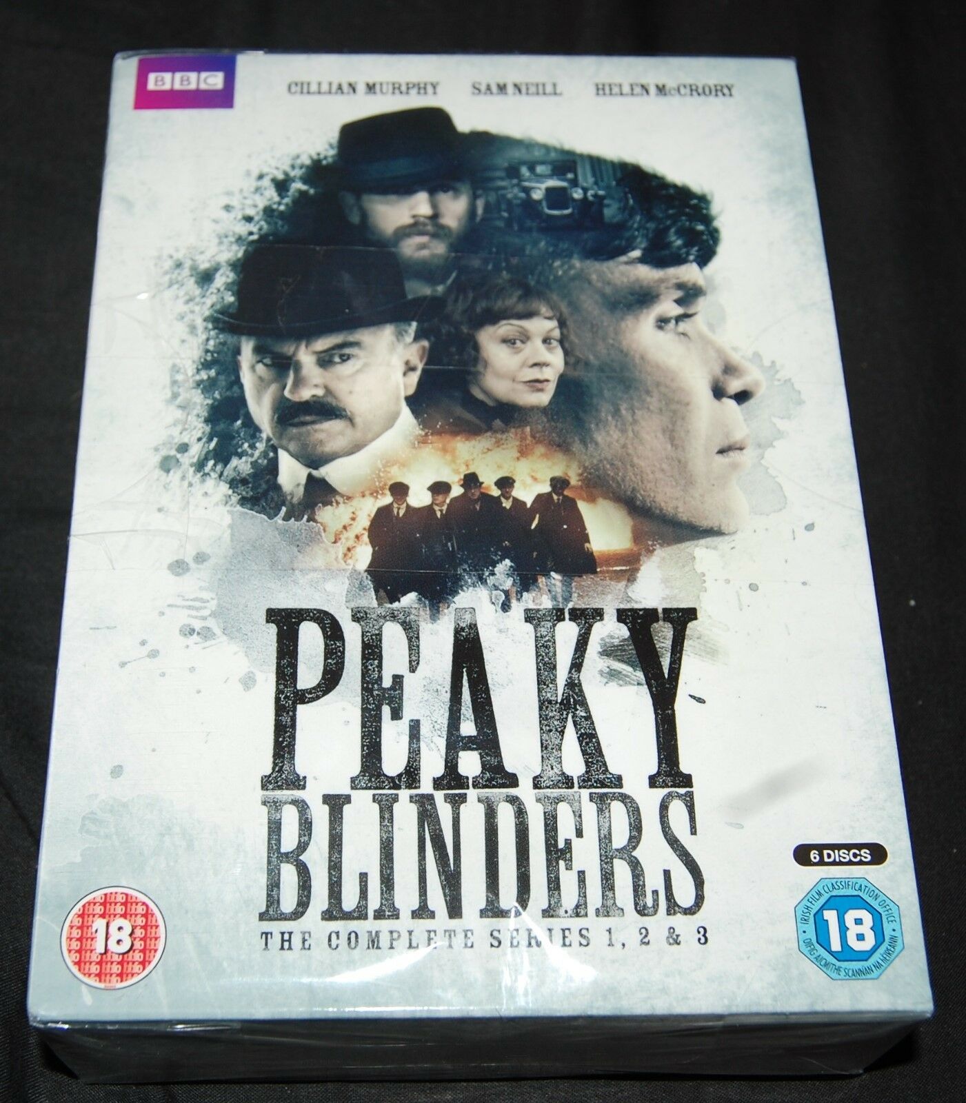 "Peaky Blinders DVD cover featuring main characters' faces and a group of men."