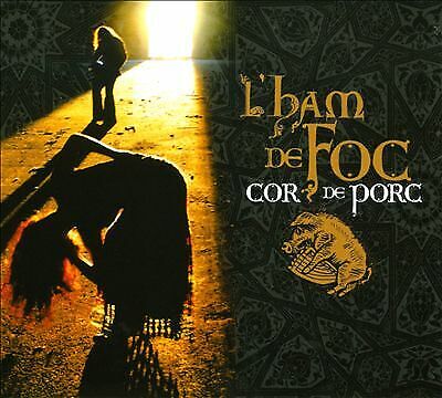 CD cover: dark silhouette, pig illustration, and golden text on patterned background.