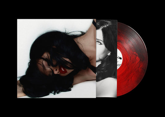 Vinyl record with red swirl and album cover featuring a woman’s face.