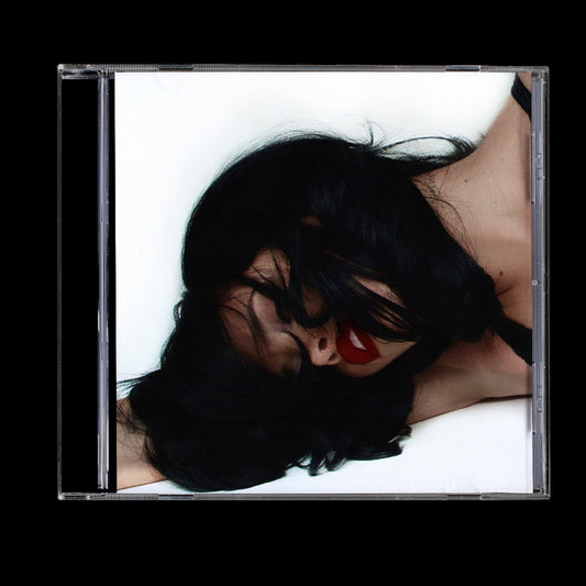 CD case featuring a woman with dark hair and red lipstick.