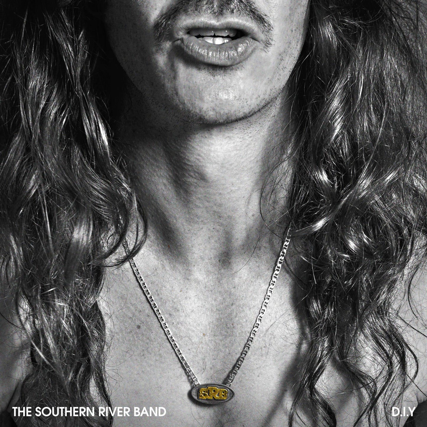 Black and white album cover featuring a man with long hair and a necklace.
