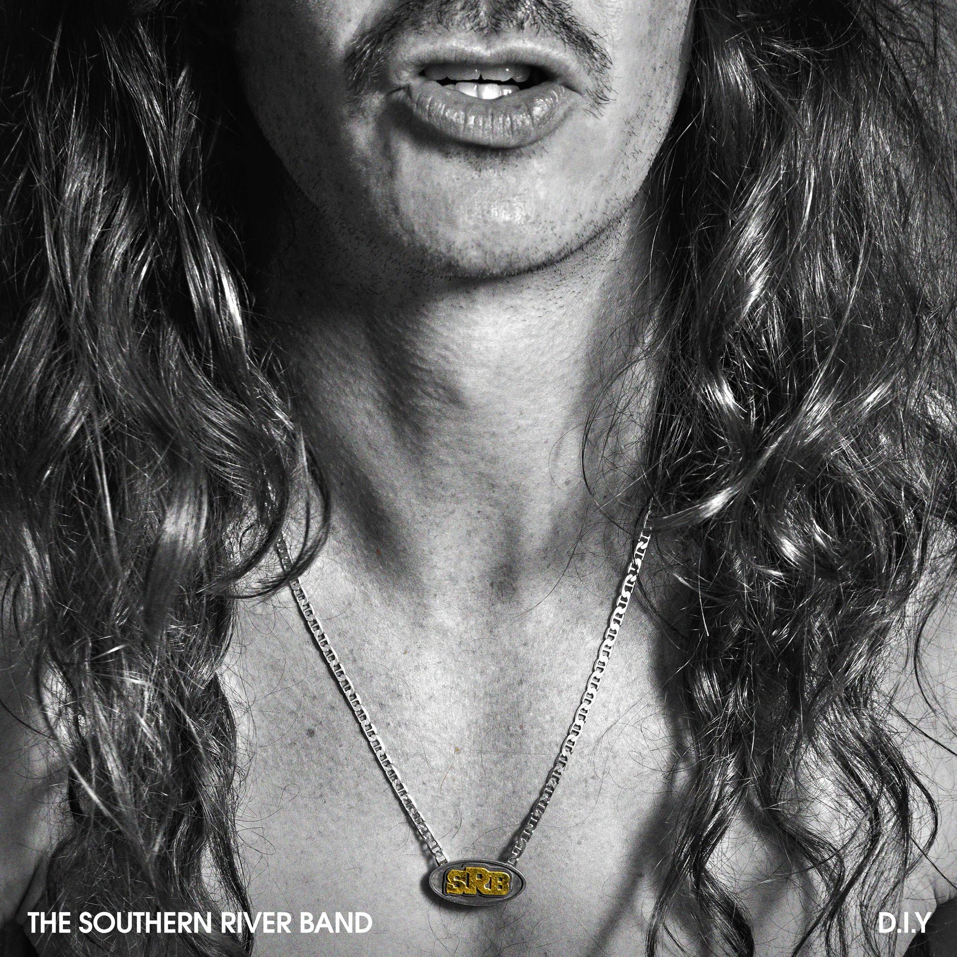 Black and white album cover featuring a man with long hair and a necklace.