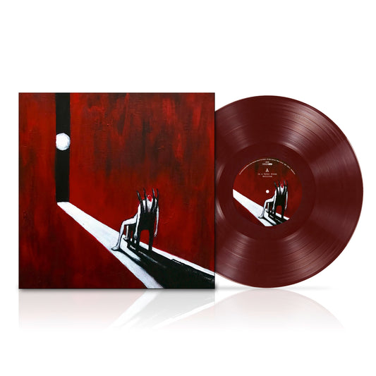 Red vinyl record and cover with a silhouetted figure in darkness.