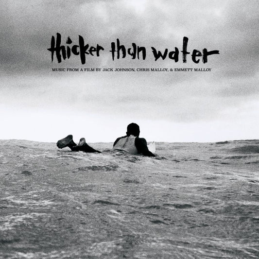 Black and white album cover with a person lying on ocean waves.