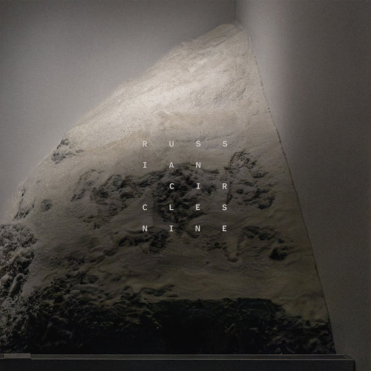 Album cover for Russian Circles’ “Nine” featuring a textured, rocky landscape.