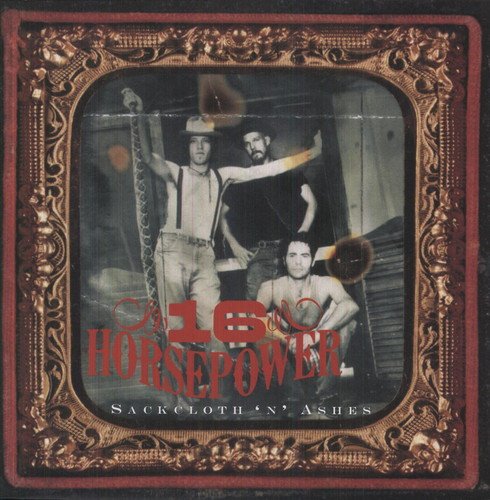 Vinyl album cover with ornate red frame and three men inside.