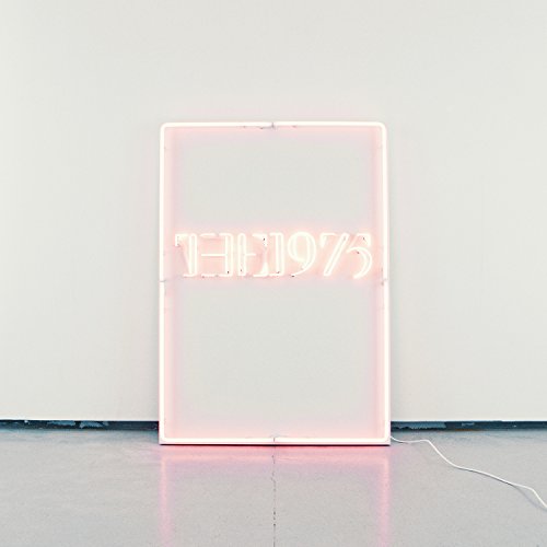 Pink neon sign spelling "THE1975" within a rectangular light box.